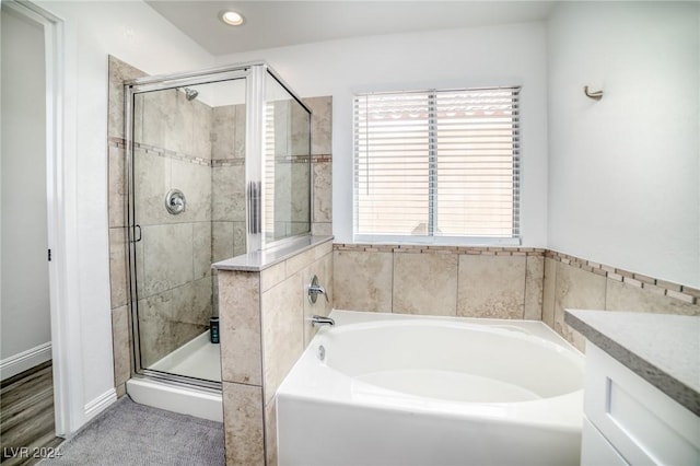 bathroom with vanity and plus walk in shower