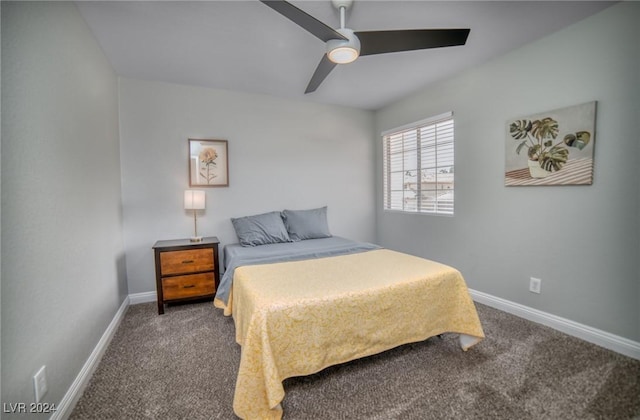 bedroom featuring ceiling fan and dark carpet