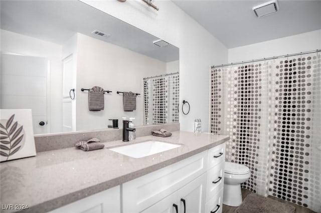 bathroom with vanity, toilet, and curtained shower