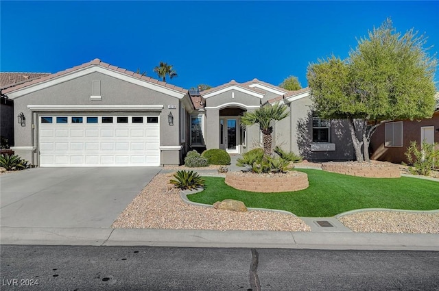 view of front facade with a front yard and a garage