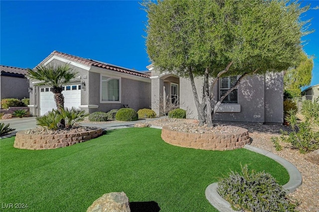 view of front of home with a garage and a front yard