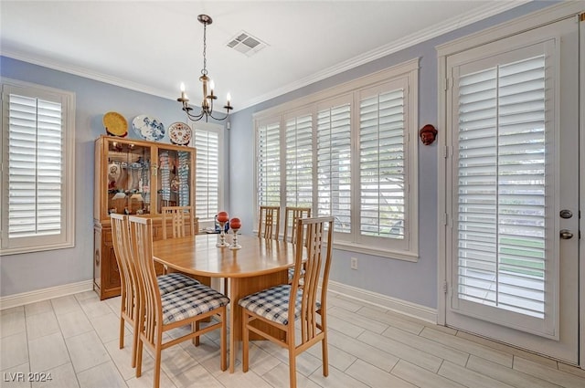 dining room featuring a chandelier, plenty of natural light, and crown molding