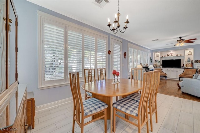 dining space with light wood-type flooring and ceiling fan with notable chandelier