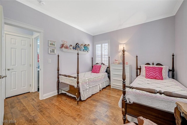 bedroom featuring hardwood / wood-style floors and crown molding