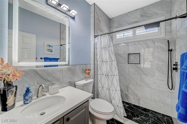 bathroom with walk in shower, vanity, toilet, and tile walls