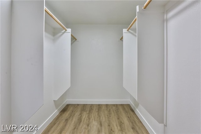 walk in closet featuring light hardwood / wood-style flooring