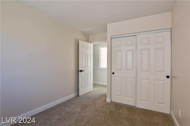 unfurnished bedroom featuring a closet and carpet