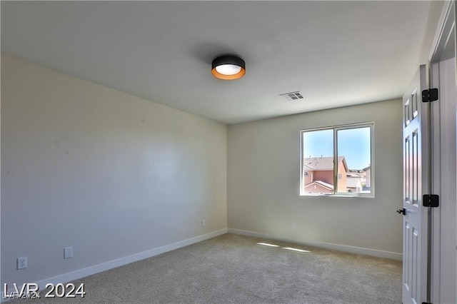 empty room featuring light colored carpet