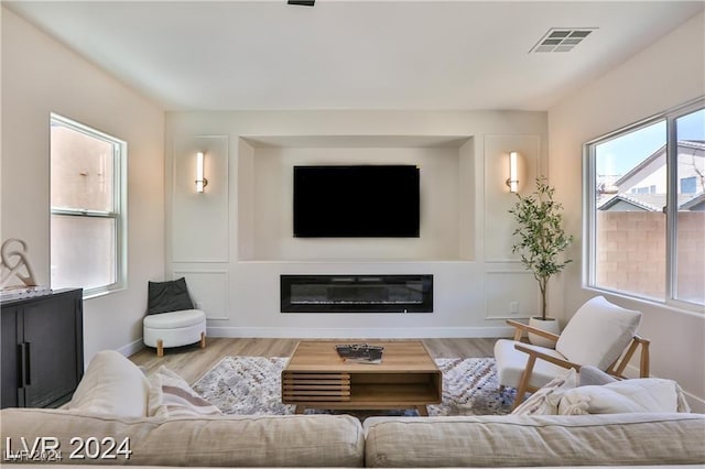 living room with light wood-type flooring and a healthy amount of sunlight