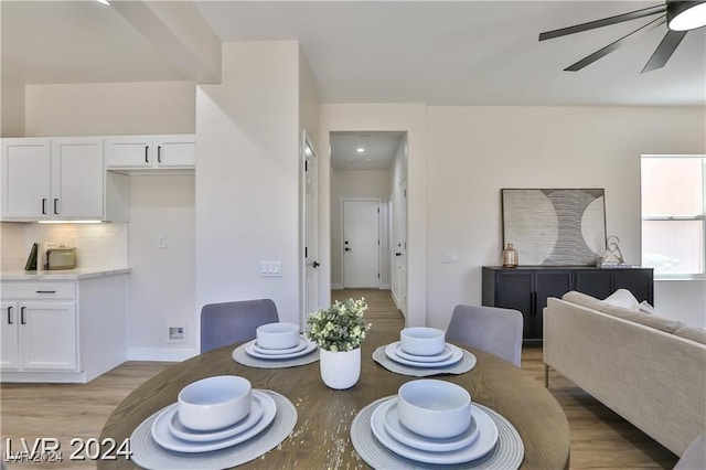 dining space featuring light wood-type flooring and ceiling fan