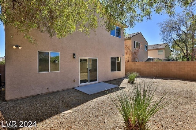 back of house with a patio