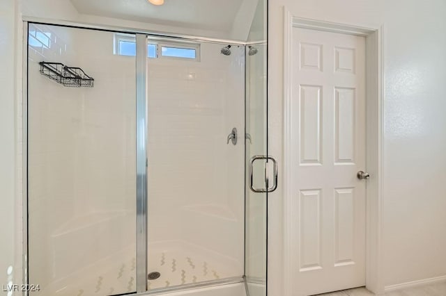 bathroom featuring a shower with door