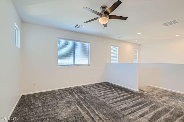 carpeted spare room with ceiling fan