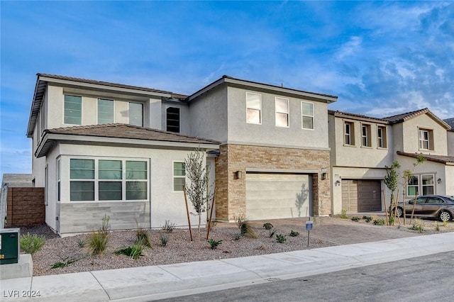 view of front of property with brick siding, decorative driveway, an attached garage, and stucco siding