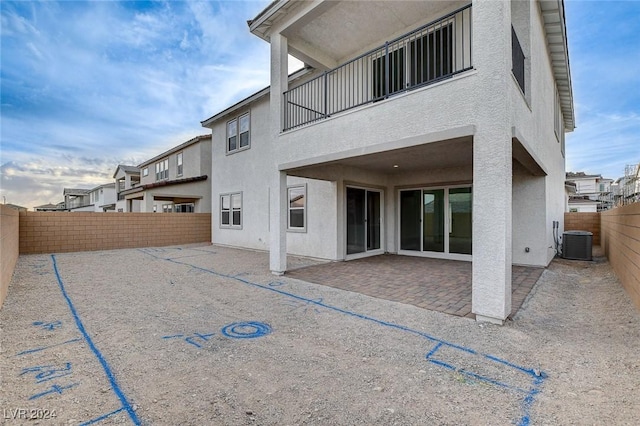 back of property featuring a fenced backyard, cooling unit, a patio, and stucco siding