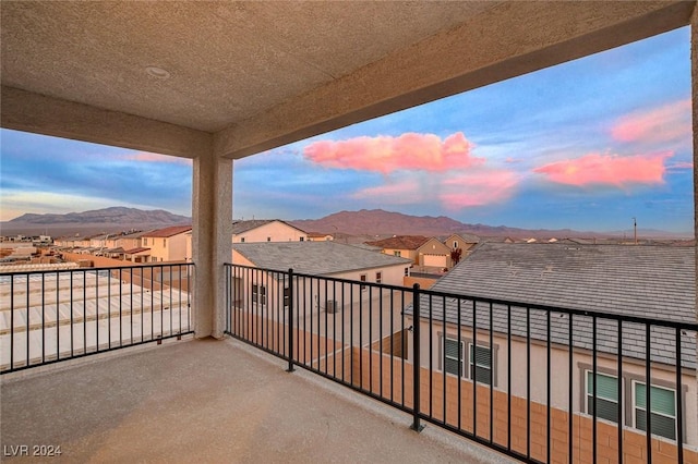 balcony featuring a residential view and a mountain view