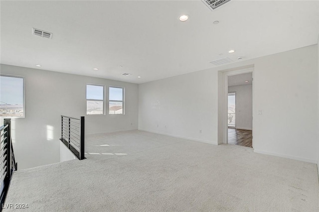 unfurnished room with baseboards, carpet, visible vents, and recessed lighting