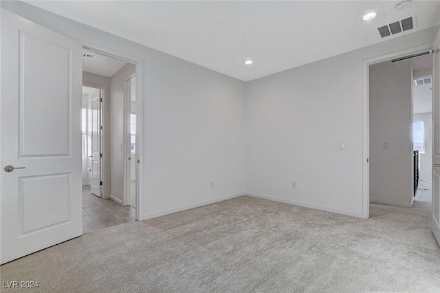 unfurnished room with carpet floors, recessed lighting, and visible vents