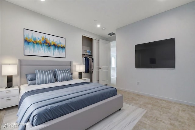 bedroom with baseboards, visible vents, light colored carpet, a closet, and recessed lighting