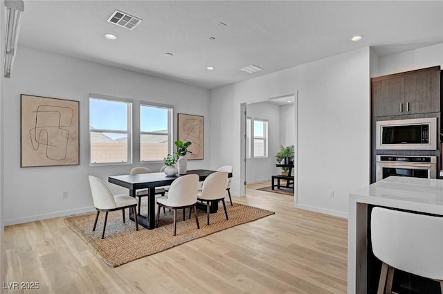 dining space featuring light wood-type flooring, visible vents, and recessed lighting