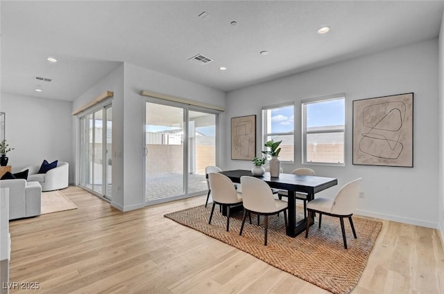 dining room featuring light wood-type flooring, baseboards, visible vents, and recessed lighting