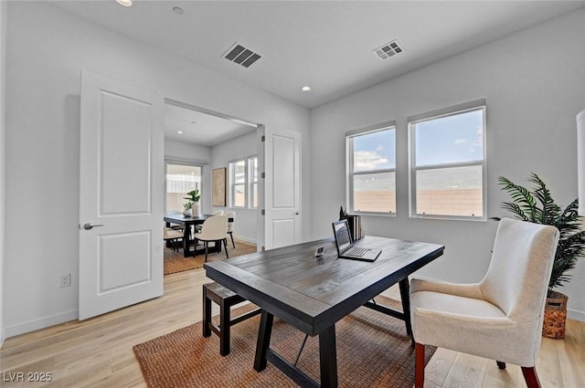 office featuring light wood-type flooring, visible vents, baseboards, and recessed lighting