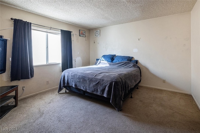 bedroom featuring carpet and a textured ceiling