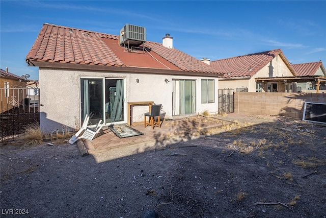 rear view of house featuring cooling unit