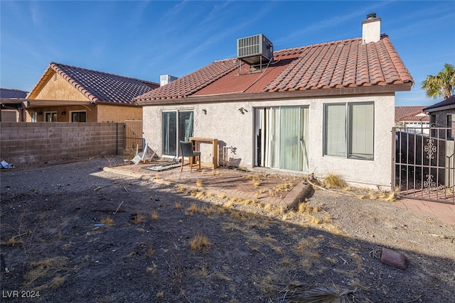 rear view of property with central AC unit