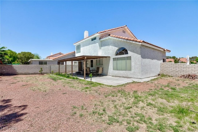 back of property with a patio