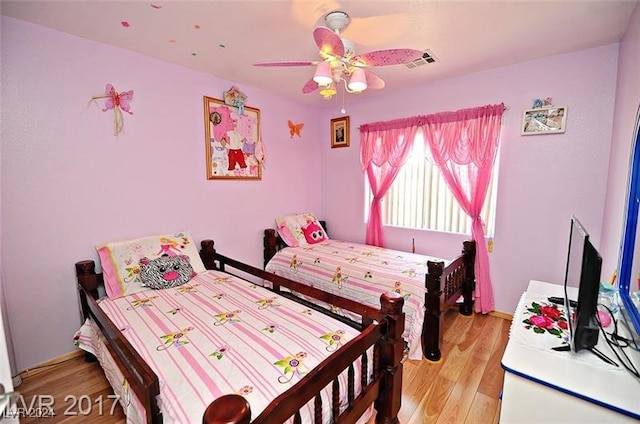 bedroom with ceiling fan and light hardwood / wood-style flooring