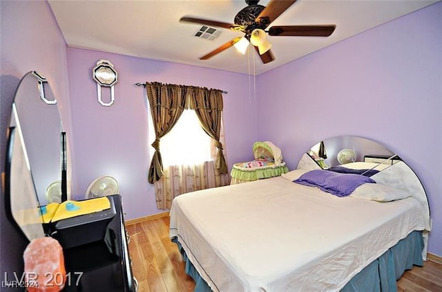 bedroom with ceiling fan and light hardwood / wood-style flooring