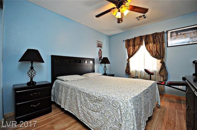 bedroom with wood-type flooring and ceiling fan