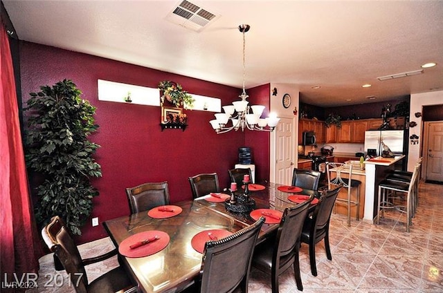 dining space with an inviting chandelier