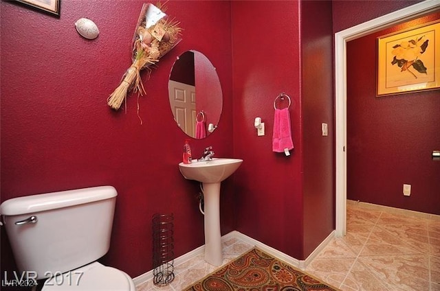 bathroom with tile patterned floors and toilet