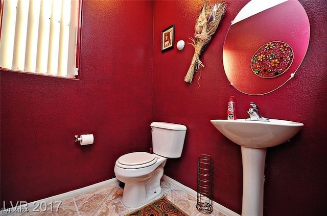 bathroom with tile patterned flooring and toilet