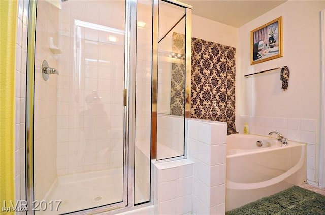 bathroom with separate shower and tub