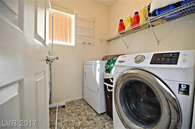 laundry area featuring washing machine and clothes dryer