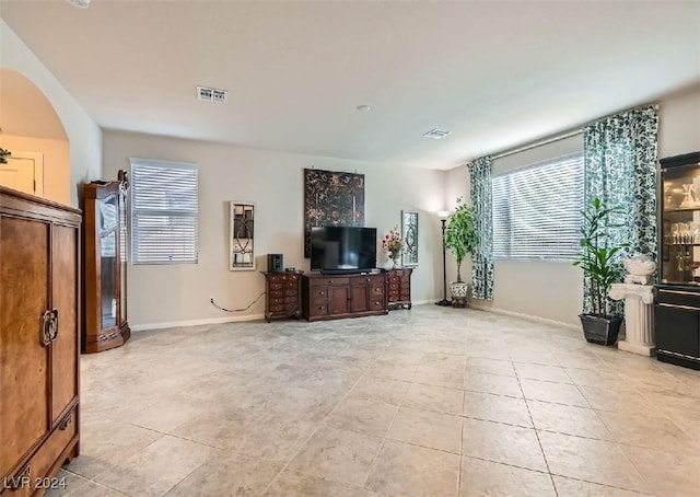 tiled living room with a wealth of natural light