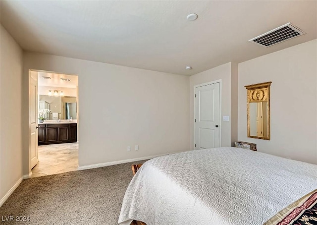 bedroom featuring light carpet and ensuite bath