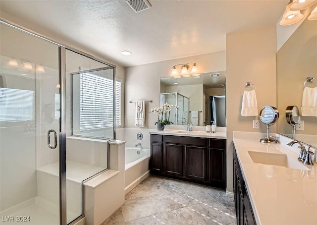 bathroom featuring vanity and shower with separate bathtub