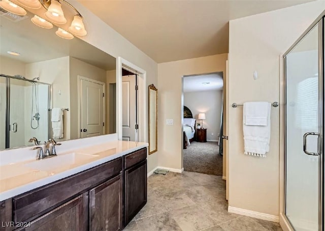 bathroom with vanity and a shower with door