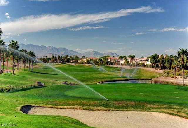 surrounding community with a water and mountain view