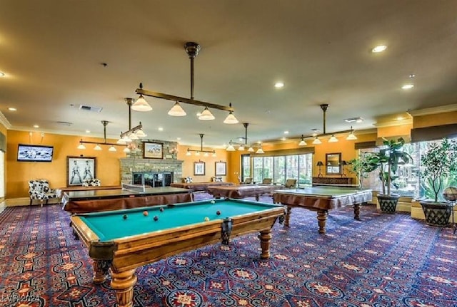 rec room with ornamental molding, a fireplace, billiards, and carpet floors