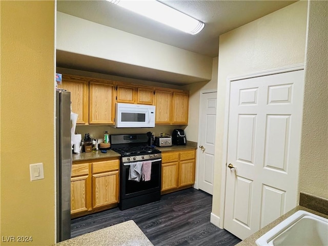 kitchen featuring dark wood-type flooring and stainless steel appliances