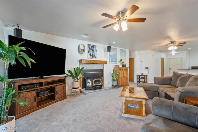 living room with light colored carpet, a wood stove, and ceiling fan