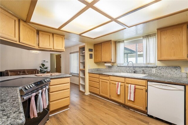 kitchen with stainless steel electric range oven, sink, white dishwasher, light brown cabinetry, and light wood-type flooring