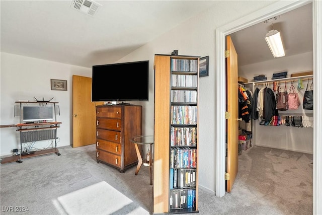 bedroom featuring light carpet and a closet