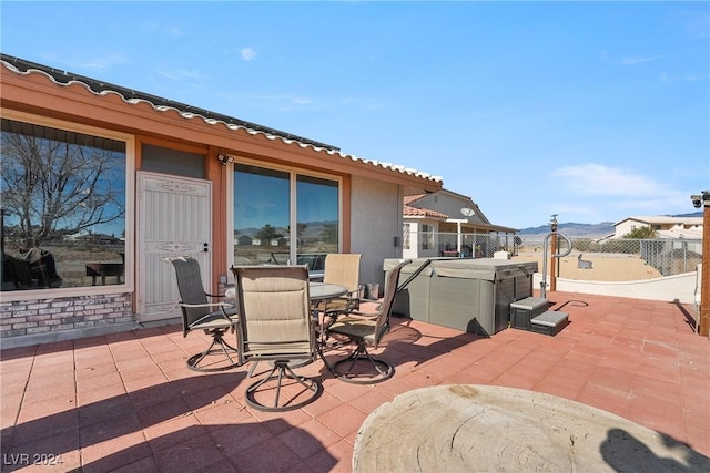 view of patio / terrace with a hot tub