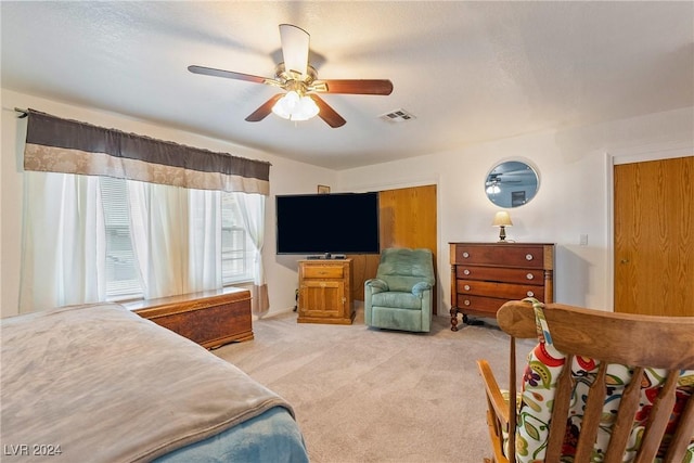 bedroom featuring light carpet and ceiling fan